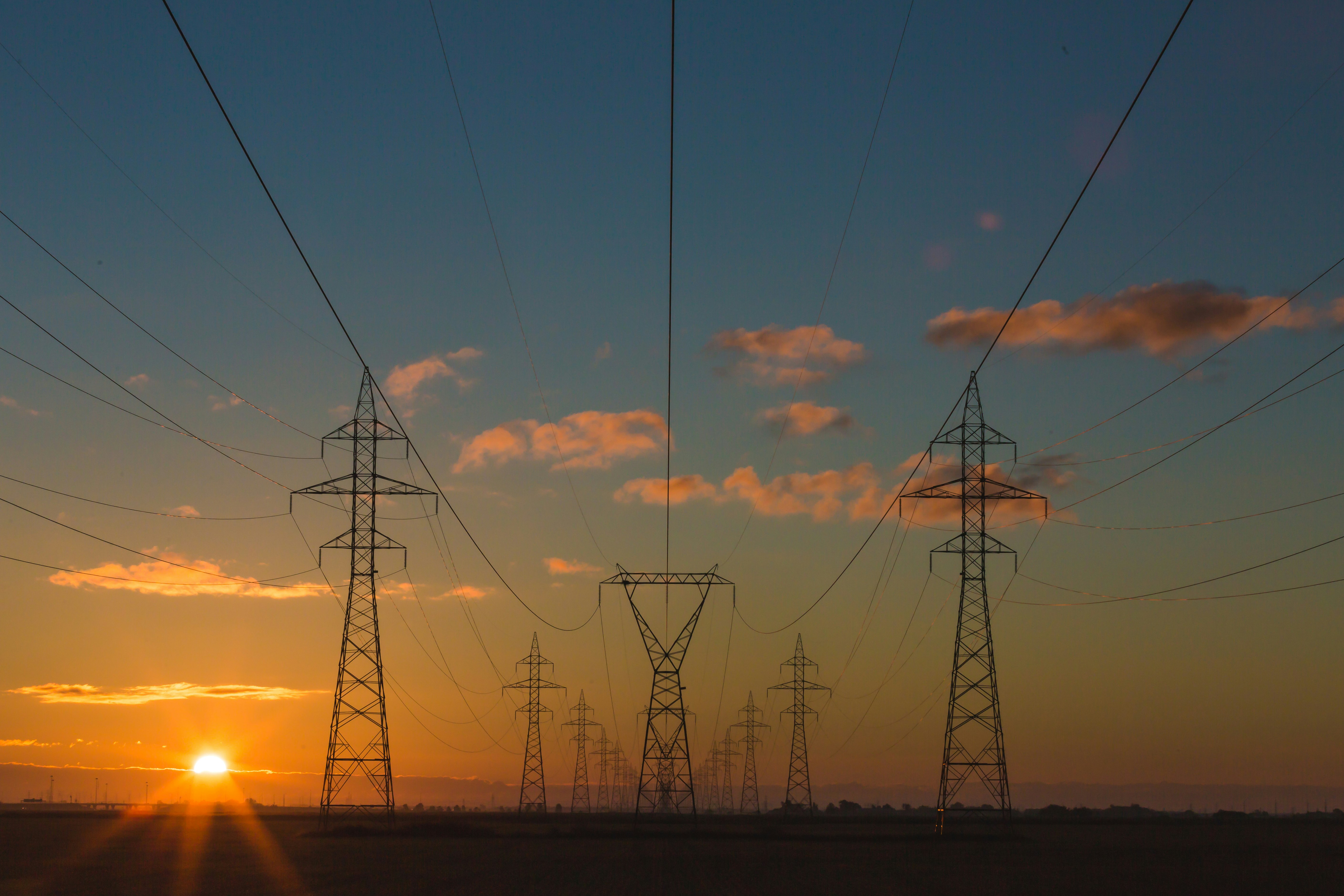 Power lines at sunset energy transition